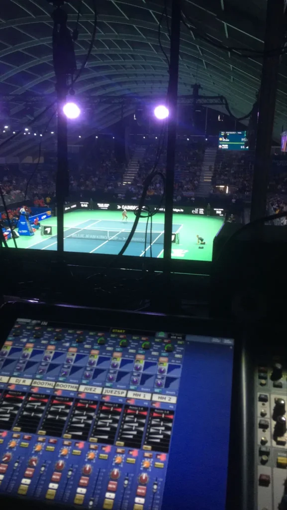 Professional sound system controls and view of the tennis court during a 2024 championship event