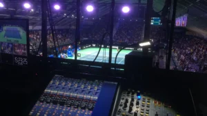 Professional sound system control panel with a live view of the tennis court during the 2024 championship