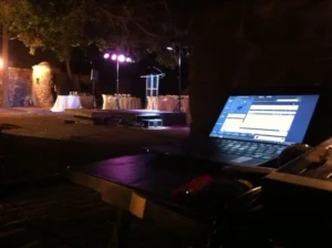 Methacrylate lectern at an outdoor event with technical support.