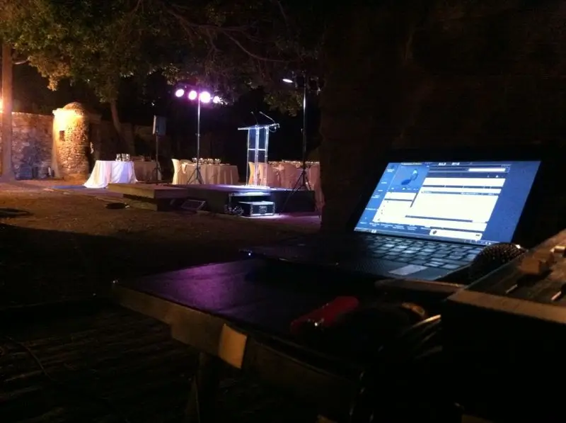 Methacrylate lectern at an outdoor event with technical support.