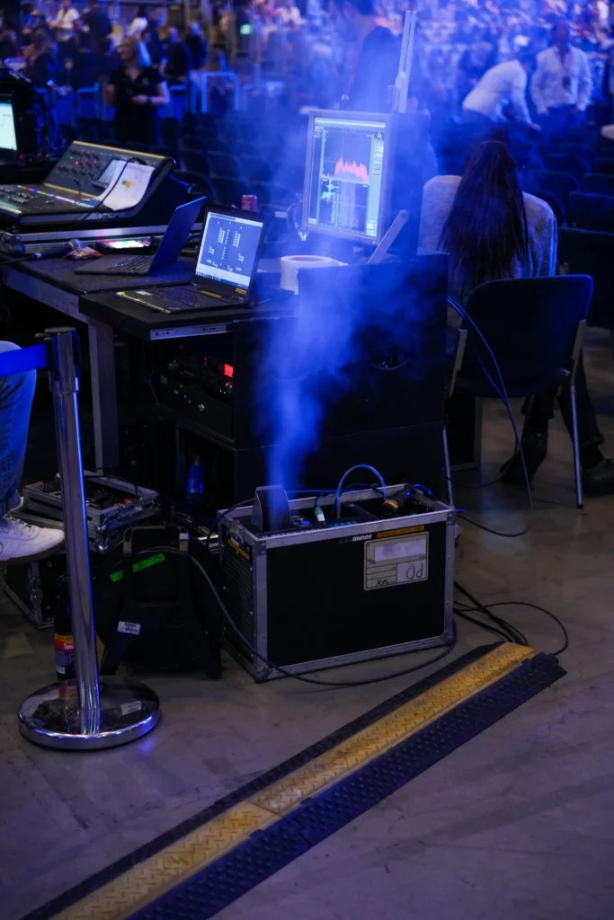 Control station with equipment and smoke effects at a live event