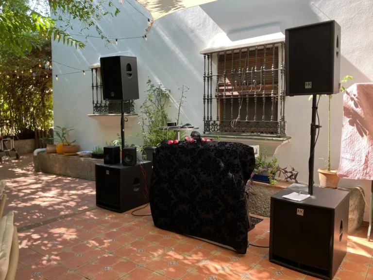 Full HK Audio column array speaker system and wireless microphone setup for outdoor DJ audio and microphone system setup in Malaga.
