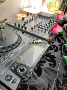 Close up of a professional DJ setup with media player and mixer at a woman DJ's event, professional DJ setup.
